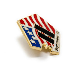 9-11 September 11, 2001 Collectible Commemorative Lapel Pin in the shape of the Pentagon building after the damage. Picturing the Twin Towers after the damage. Designed with red, white, and blue American flag details, with the words "September 11” in a black text.
