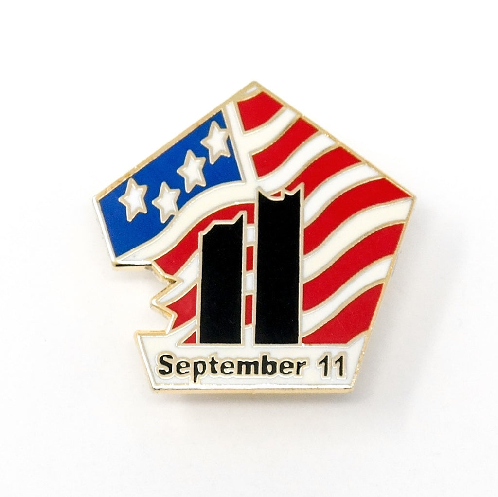 9-11 September 11, 2001 Collectible Commemorative Lapel Pin in the shape of the Pentagon building after the damage. Picturing the Twin Towers after the damage. Designed with red, white, and blue American flag details, with the words "September 11” in a black text. 