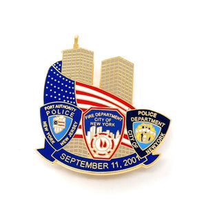 9-11 September 11, 2001 Collectible Commemorative Lapel Pin honoring first responders on that day. Image of the Twin Towers in the center, wrapped color enamel American flag with detailed badges for the New York, New Jersey Port Authority Police, the City of New York Fire Department, and the City of New York Police Department, with September 11, 2001 along the bottom with a blue banner. 